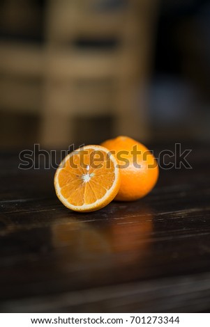 Colorful of fresh fruits (orange) on wooden table. Close up healthy fruit on black background. Royalty high quality free stock image.