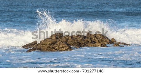 Crashing waves along rocky California coastline