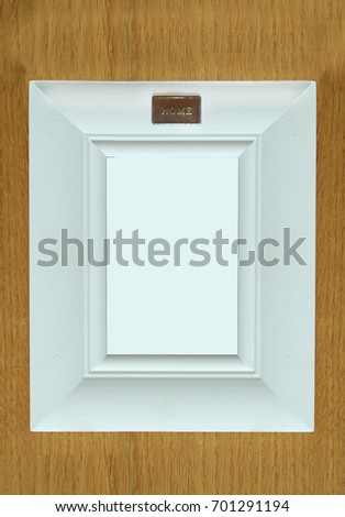 White frame for photography on a wood background.
