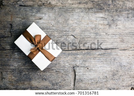 Vintage gift box with bow on wooden background