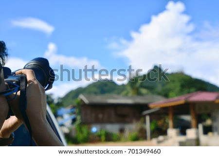 Photographer taking a picture with blue sky background