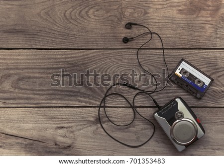 Vintage walkman cassette player with earbuds and tape cassette Royalty-Free Stock Photo #701353483