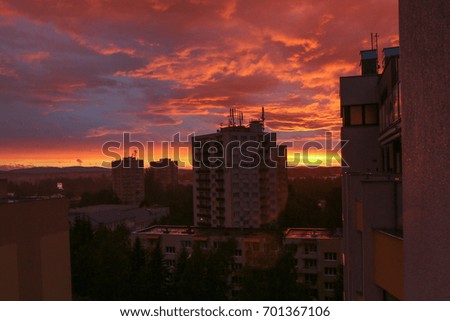 A picture of the old blocks of flats in the city during the colorful sunset. 