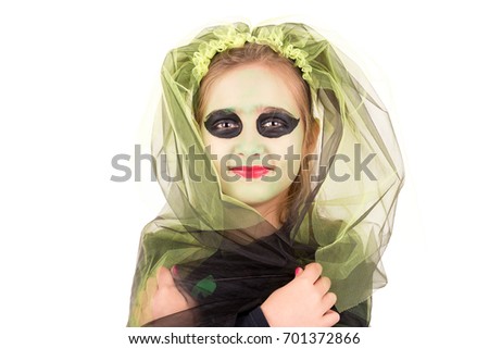 Girl with face-paint and Halloween witch costume over a white background