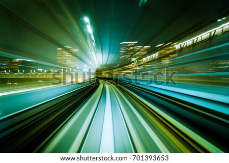 Motion blurred front view of train running in modern city tunnel. Abstract transportation background.