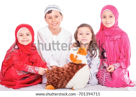 Happy little Muslim kids playing with sheep toy - celebrating Eid ul Adha - Happy Sacrifice Feast Royalty-Free Stock Photo #701394715