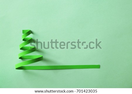Christmas tree made of paper on green background