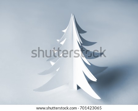 Christmas tree made of paper on light background
