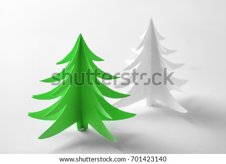 Christmas trees made of paper on white background