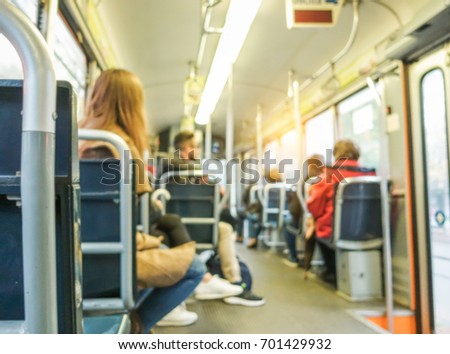 Blurred people inside bus city tram - Defocused image - Transportation and travel concept - Warm filter - Blurry photo
