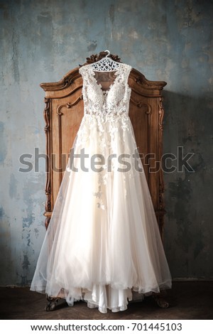 Wedding dress is hanging on the closet. Stylish photo Royalty-Free Stock Photo #701445103