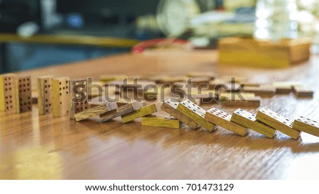 Row of wooden dominoes effect on the table