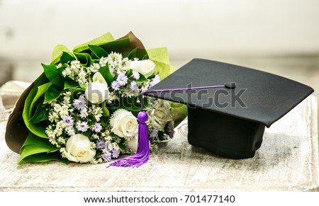 Graduation cap and beautiful flower Royalty-Free Stock Photo #701477140