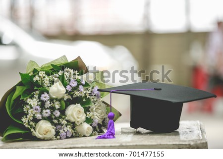 Graduation cap and beautiful flower Royalty-Free Stock Photo #701477155