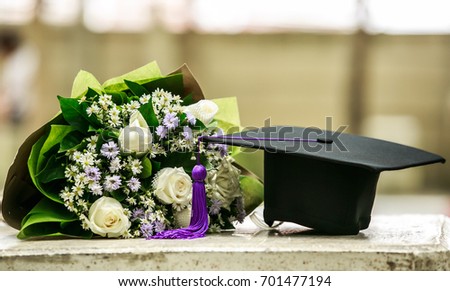Graduation cap and beautiful flower Royalty-Free Stock Photo #701477194