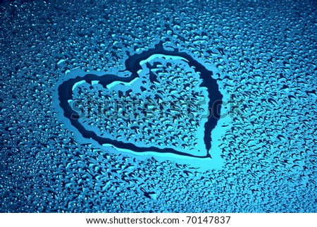 Heart on blue wet surface