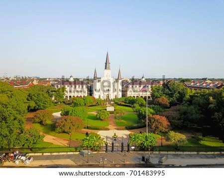 Aerial view of Jackson Square with Saint Louis Cathedral church in morning. A National Historic Landmark in New Orleans, Louisiana history. Horse and carriages wait to take people on city tours.