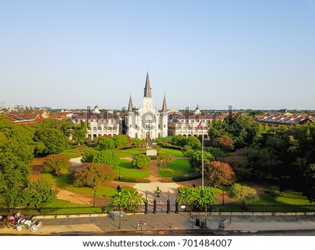 Aerial view of Jackson Square with Saint Louis Cathedral church in morning. A National Historic Landmark in New Orleans, Louisiana history. Horse and carriages wait to take people on city tours.