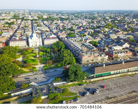 Aerial view of Jackson Square with Saint Louis Cathedral church, surround extant historical buildings from French Quarter and Washington Artillery Park in morning. New Orleans travel background.