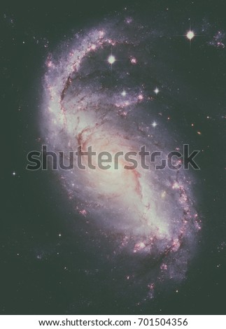Stellar Nursery in the arms of NGC 1672. NGC 1672 is a barred spiral galaxy located in the constellation Dorado. Retouched image. Elements of this image furnished by NASA.