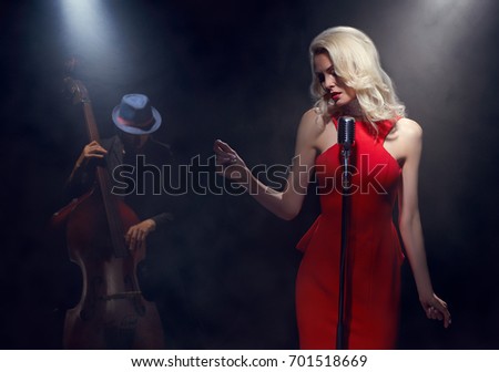 The jazz singer. Contrabass and bass clarinet. Royalty-Free Stock Photo #701518669