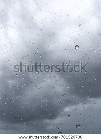 Rain drops on glass and rain storm In the rainy season.