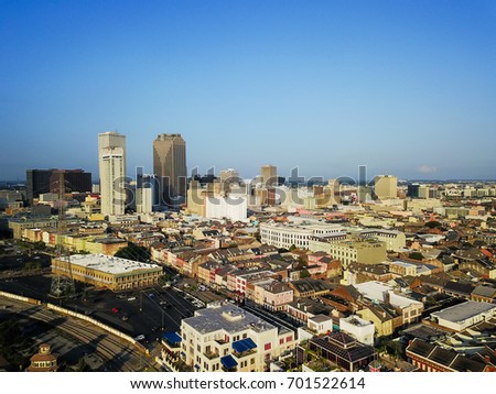 Aerial view Central Business District (CBD), a Mississippi riverside downtown of New Orleans at sunrise. Preserved 19th century French Quarter building in front of skyscrapers and modern office towers