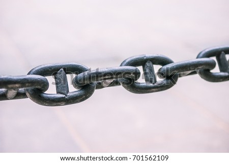 Close up of a rusty anchor chain on bright background