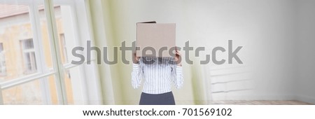 Digital composite of Woman with a box on her head standing in her new house