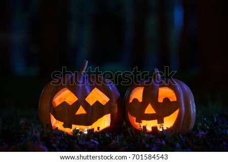 Two Halloween Pumpkins In A Mystic Forest At Night