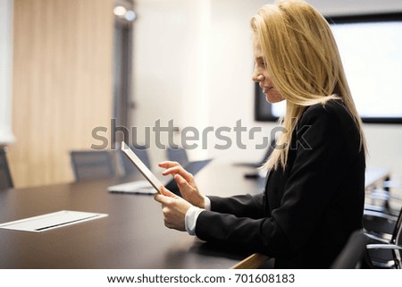 Portrait of beautiful blonde businesswoman holding tablet