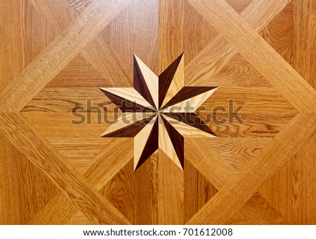 Wood marquetry star shape at floor parquet Royalty-Free Stock Photo #701612008