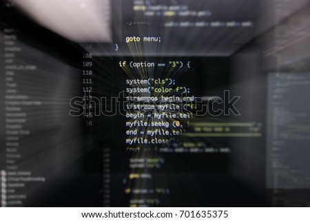 Real  code developing screen. Programing workflow abstract algorithm concept. Lines of c / c++ code visible under magnifying lens with moviment effect.