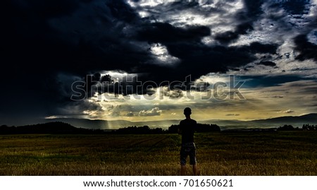 facing the storm in a field