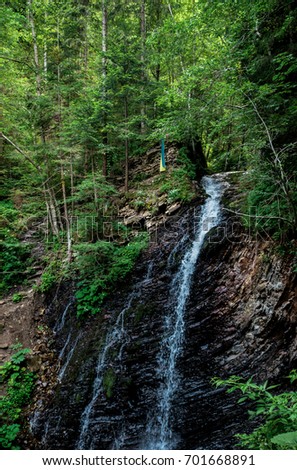 Idyllic and beautiful view of Ukrainian waterfall Huk in Carpathian Mountains.  