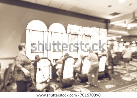Blur slot machines, themed game, roulette slot poker 777, armed bandit with players at casino in Louisiana. Colorful illuminated light row digital machines. Gambling abstract background. Vintage tone