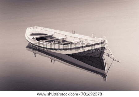 A Calming black and white picture of an Old boat 