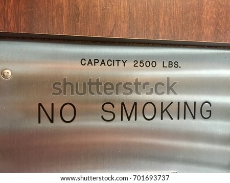 Capacity 2500 pounds no smoking elevator door sign
