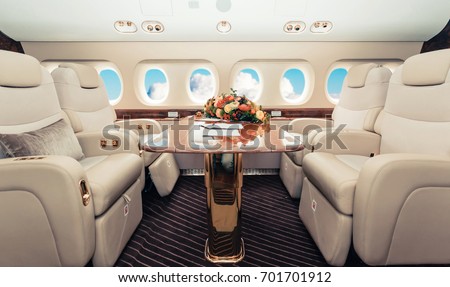 Luxury interior in bright colors of genuine leather in the business jet Royalty-Free Stock Photo #701701912
