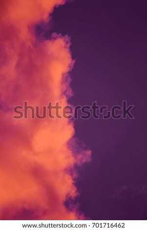 Magnificent colorful clouds in the evening sky. Bright, pink clouds in the sky at sunset. Beautiful evening skyscape. Abstract, purple pink background. Vibrant color photograph.
