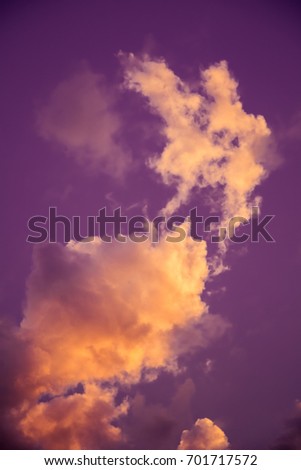 Magnificent colorful clouds in the evening sky. Bright, pink clouds in the sky at sunset. Beautiful evening skyscape. Abstract, purple pink background. Vibrant color photograph.