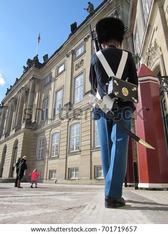 The guards of honour guarding the Royal residence Amalienborg Palace in Copenhagen, Denmark Royalty-Free Stock Photo #701719657
