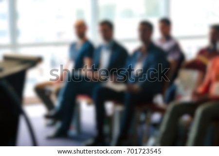 Blur of business meeting in conference hall.