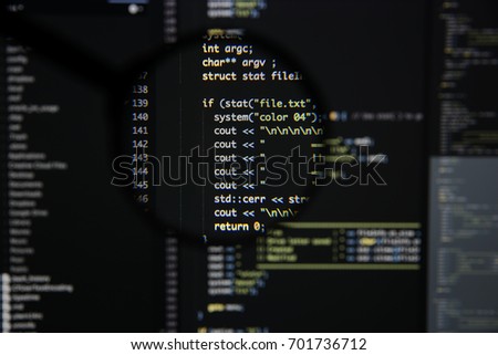 Real c / c++ code developing screen. Programing workflow abstract algorithm concept. Lines of c / c++ code visible under magnifying lens.