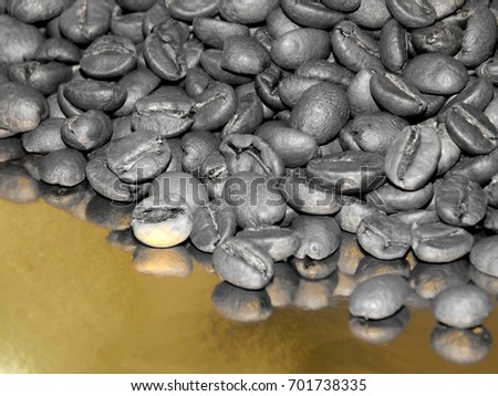 Fried coffee beans on a black and white image on a golden background