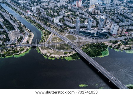 Residential district in a large metropolis with road junctions and houses near Dnepr river in Kiev, Ukraine. Aerial view. From above.