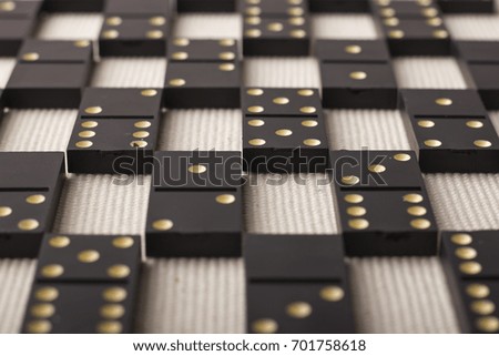 Dominoes are black. Light background. The game is tabletop 