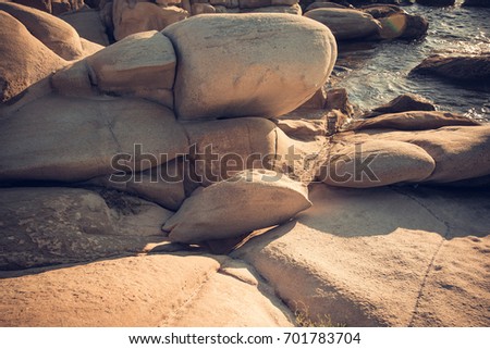 Pile of stones and the sea behind / Beautiful coast in Greece while sun rising 