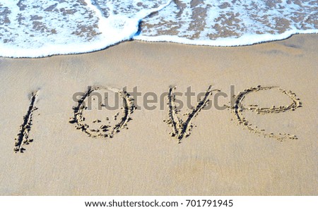 The word love on the beach background