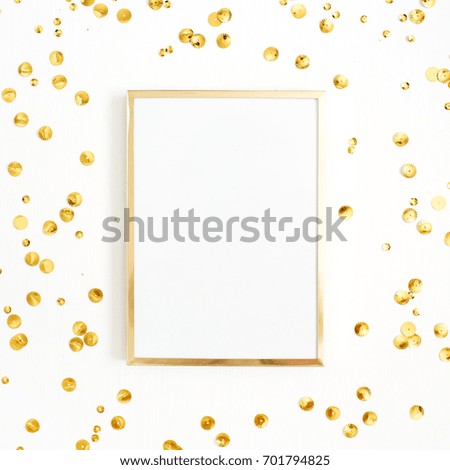 Photo frame mock up with space for text and golden confetti tinsel  on white background. Flat lay, top view. Minimal background.